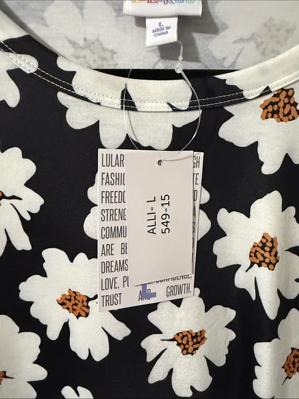 LuLaRoe Black Short Sleeve Tee with White and Golden Daisy Print - Picture 2 of 5